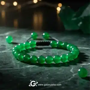 دستبند سنگ عقیق سبز یمنی / Green Agate Bracelet دستبند عقیق سبز یمنی طبیعی ساخته شده از سنگ عقیق اصل و درجه یک، یکی از خاص‌ترین زیورآلات سنگی گلکسی آرت است که با رنگ سبز شفاف و انرژی‌بخش خود، جلوه‌ای منحصربه‌فرد به استایل شما می‌بخشد. این دستبند با سنگ‌های تراش گرد سایز ۸ میل طراحی شده و به صورت فری سایز تنظیمی در دو سایز زنانه و مردانه ارائه می‌شود. سنگ عقیق سبز از گذشته در فرهنگ‌های مختلف به عنوان نماد آرامش، سلامت و تعادل درونی شناخته شده و اعتقاد بر این است که با خود انرژی مثبت، افزایش اعتماد به نفس و محافظت در برابر استرس به همراه دارد. رنگ سبز این سنگ، تداعی‌کننده طبیعت و حس طراوت است و می‌تواند در ایجاد آرامش ذهنی و روحی نقش مهمی داشته باشد. این دستبند علاوه بر زیبایی چشمگیر، به عنوان سنگ ماه تولد اردیبهشت و خرداد شناخته می‌شود و می‌تواند هدیه‌ای معنادار و ارزشمند برای متولدین این ماه‌ها باشد. ترکیب رنگ سبز درخشان عقیق با طراحی ساده و شیک، آن را به اکسسوری‌ای مناسب برای استفاده روزمره و موقعیت‌های رسمی تبدیل کرده است. ویژگی‌ها: سنگ عقیق سبز یمنی طبیعی و درجه یک تراش گرد سایز ۸ میل فری سایز با قابلیت تنظیم موجود در دو سایز زنانه و مردانه سنگ ماه تولد اردیبهشت و خرداد نماد آرامش، سلامت و اعتماد به نفس مناسب برای استفاده روزمره و هدیه‌ای خاص